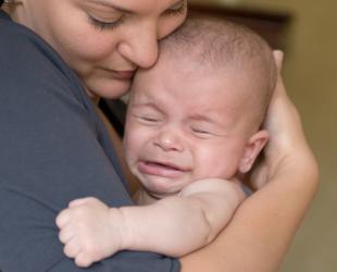 Baby fussing on sales breast in evening